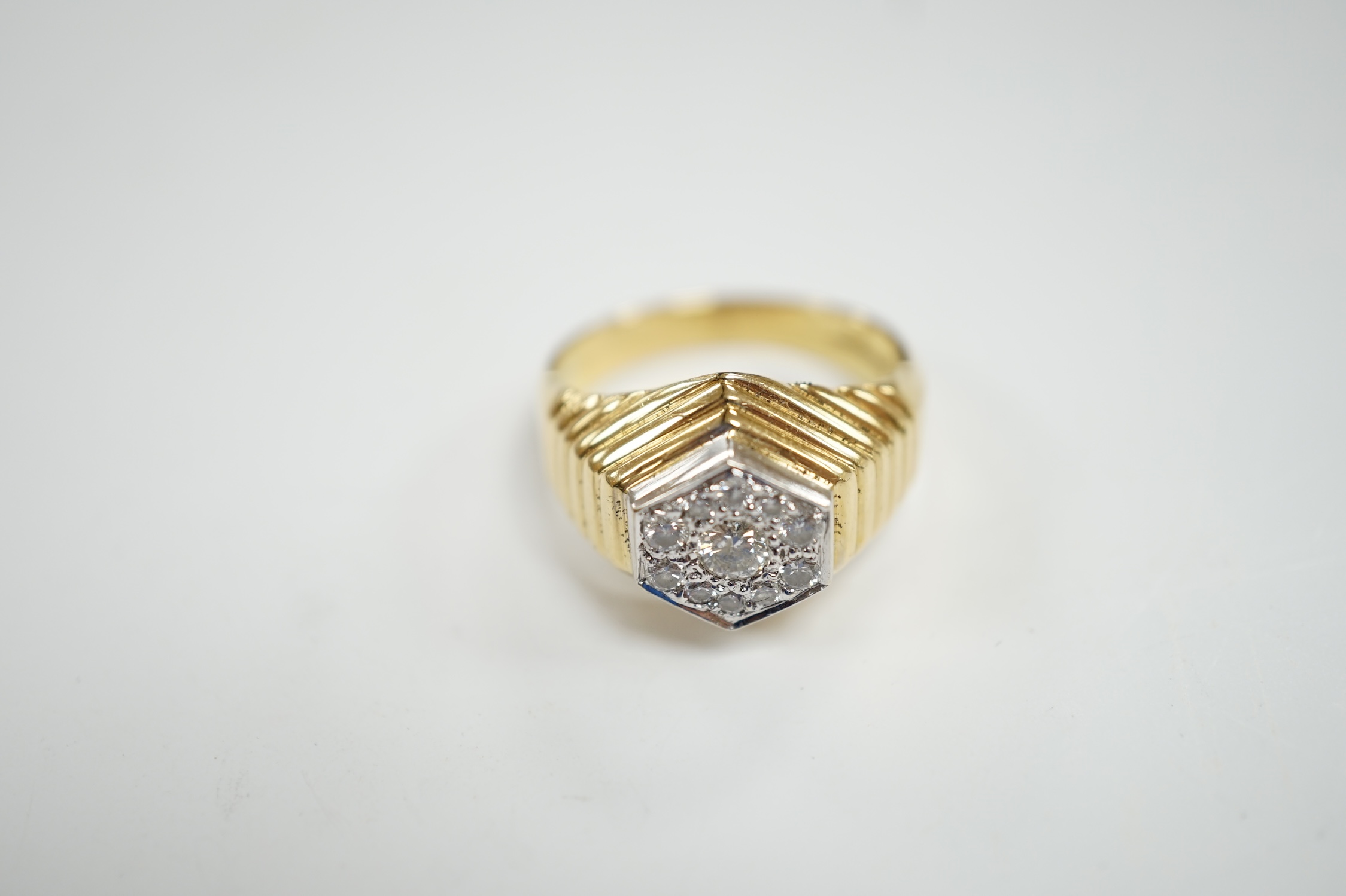 A modern 18ct gold and diamond set hexagonal cluster ring, size Q, gross weight 11.3 grams.